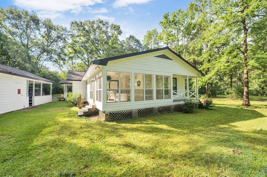 Sunroom with side view of workshop and carport
