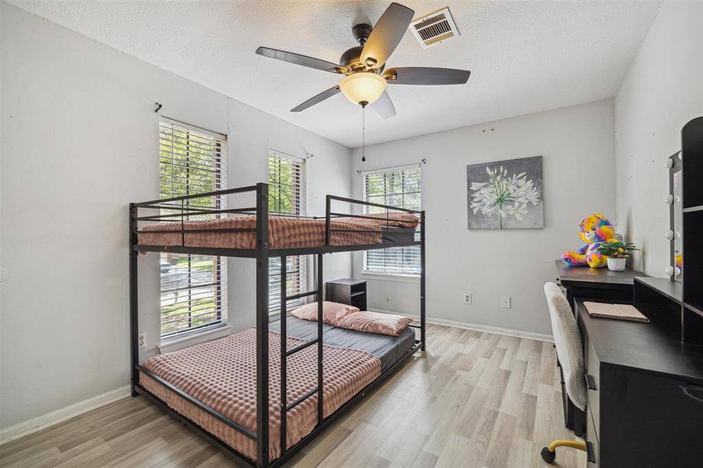 Upstairs secondary bedroom with ample closet space.