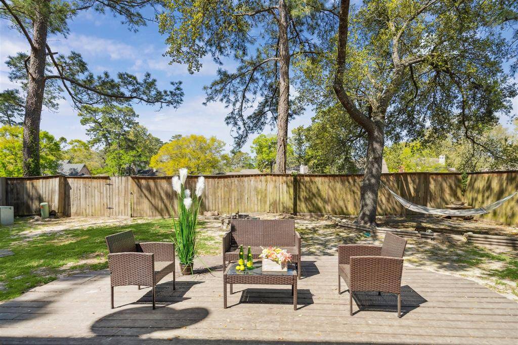 Expansive, fully fenced backyard with a welcoming deck.