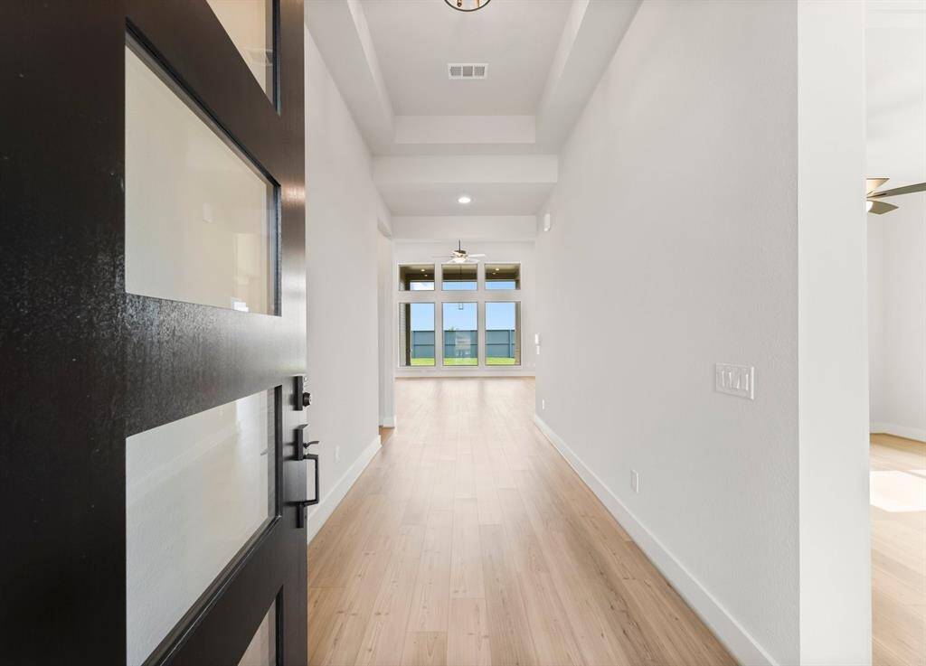 Open the Entry Door to Reveal 12' Tray Ceiling and Luxury Vinyl Plank Flooring