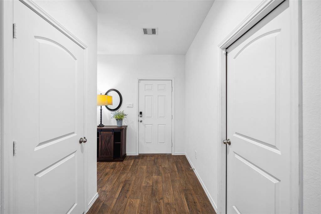 Welcoming entry foyer with storage closet on the left & garage entry on the right..