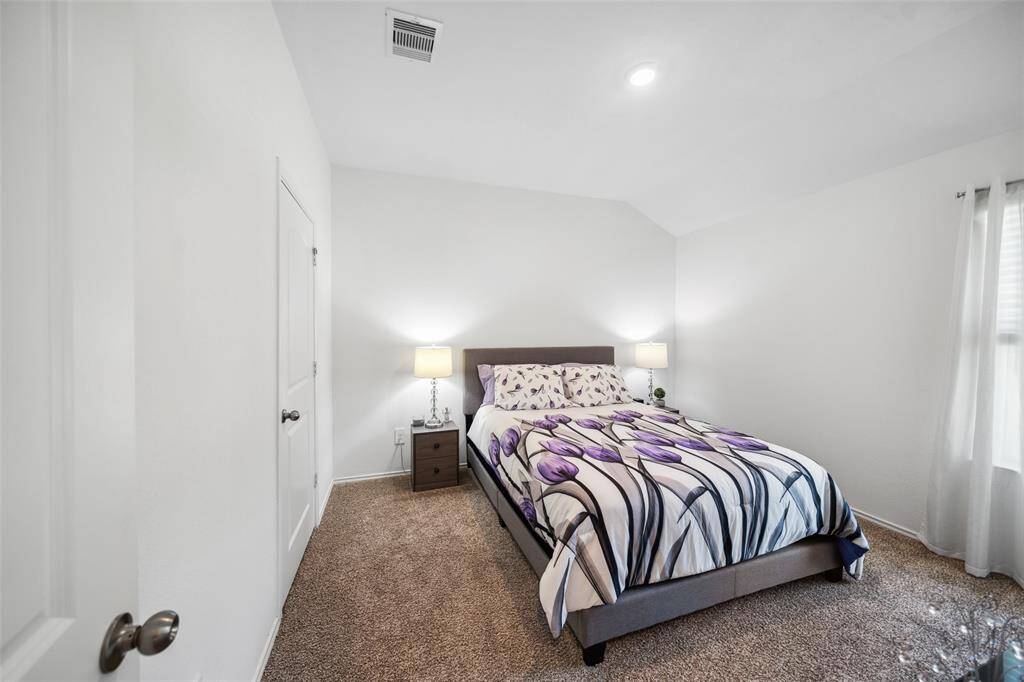 Secondary Bedroom #3 located on the side of the home, with great view of the woods.