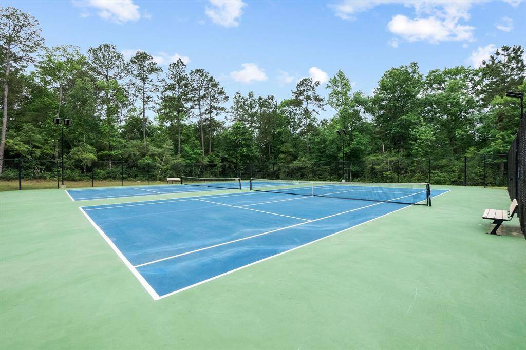 A bird's-eye view of vibrant living at The Woodlands Hills Community. From walking tails to the serene lap pool, the winding lazy river, tennis courts, and bustling parks, every corner of this community center is a testament to active living and boundless enjoyment. Welcome to a place where every day brings new adventures and cherished memories.
