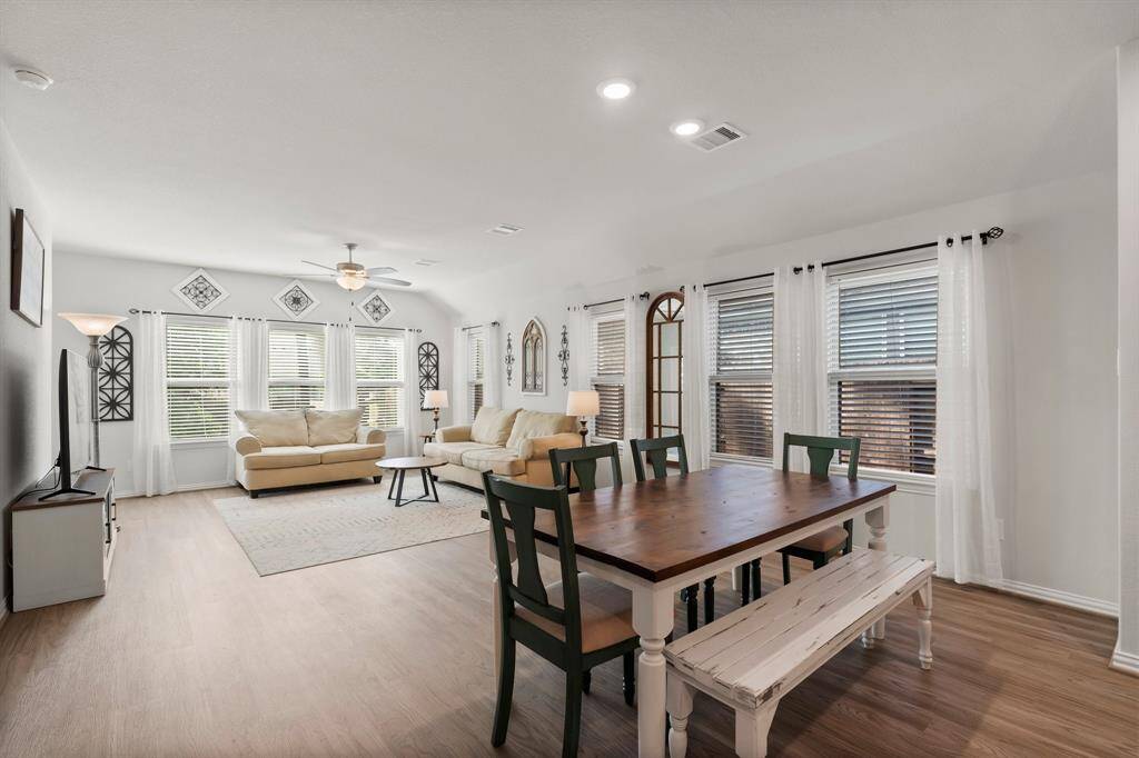 Experience the heart of the home in this beautifully appointed kitchen, featuring a spacious island with a double sink, sleek countertops, and rich cabinetry. Equipped with modern stainless steel appliances and stylish backsplash, it's perfect for culinary creations and entertaining.