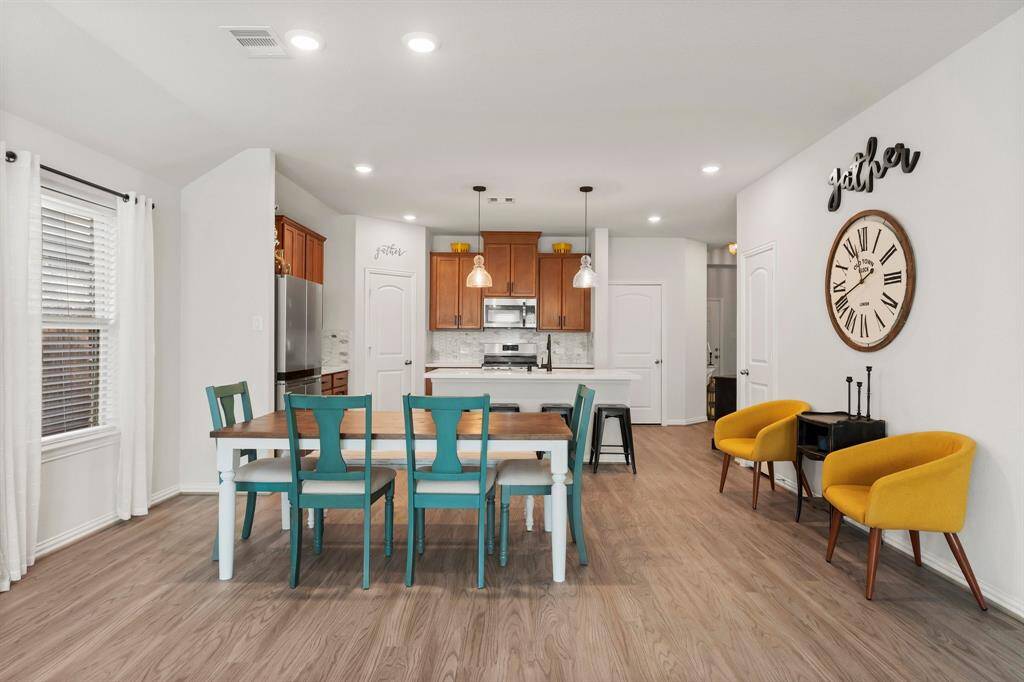 Seamlessly transition from cooking to dining in this open-concept layout, where the spacious kitchen flows effortlessly into the dedicated dining area. Perfect for entertaining, this inviting space allows for natural interaction and gathering.