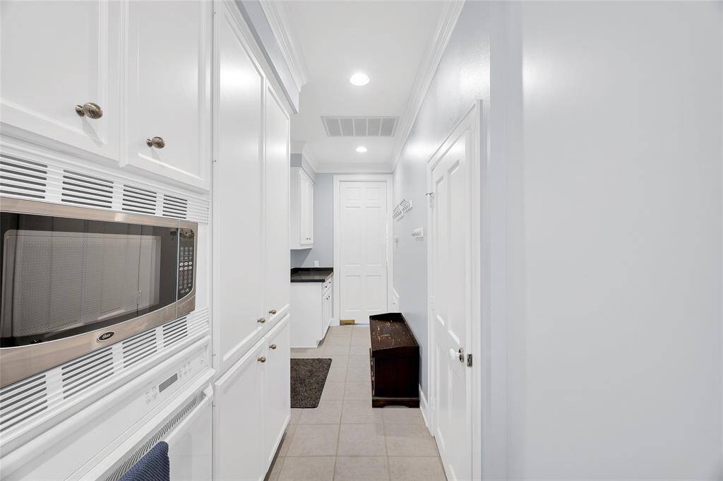 Kitchen leads to mudroom area with side exit to the driveway
