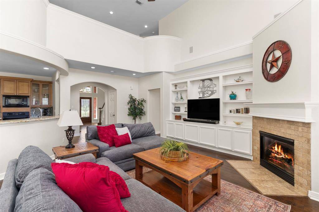 The Family Room features a convenient built-in cabinet and shelves, providing ample space for a TV, décor, and treasured items. With plenty of room for large furniture and 4 built-in wall speakers, this inviting space is perfect for entertainment and relaxation.