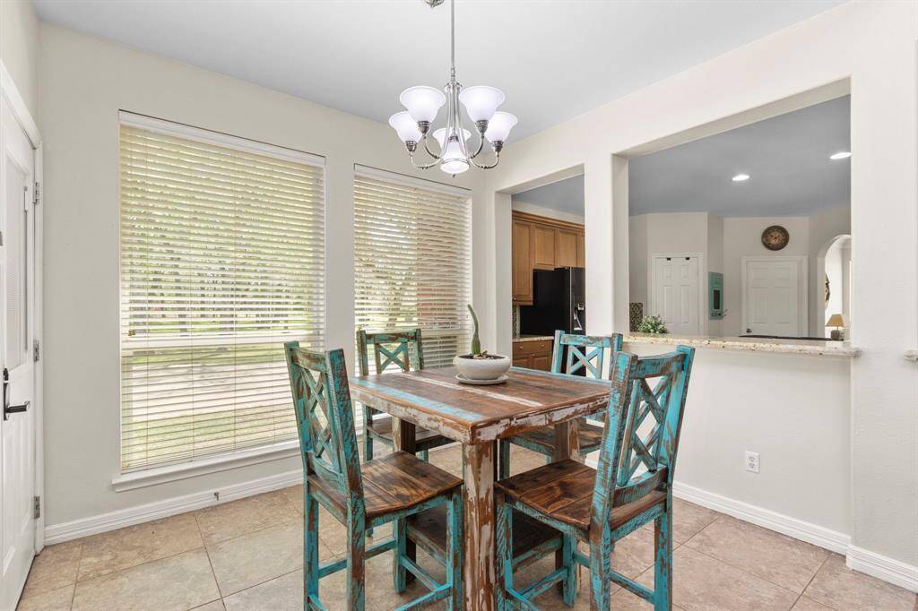 This view highlights its close proximity to the Kitchen, with the elegant 18x18 tile floors extending seamlessly throughout. The open layout enhances flow and functionality, making it a perfect spot for casual dining and gatherings.