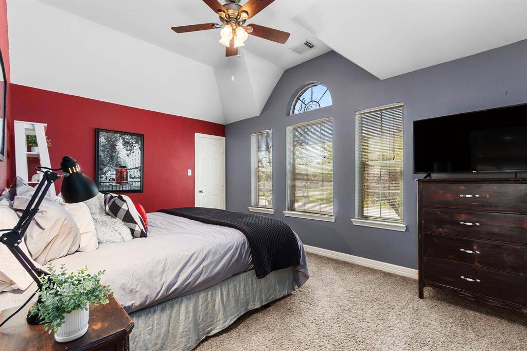 The second floor also features 3 spacious Bedrooms and a Full Bath. Each Secondary Bedroom is generously sized, complete with walk-in closets, plush carpeting, and elegant oil-rubbed bronze ceiling fans for added comfort and style. This Bedroom also features a vaulted ceiling, adding architectural interest and a sense of spaciousness while enhancing the room's bright and airy atmosphere.