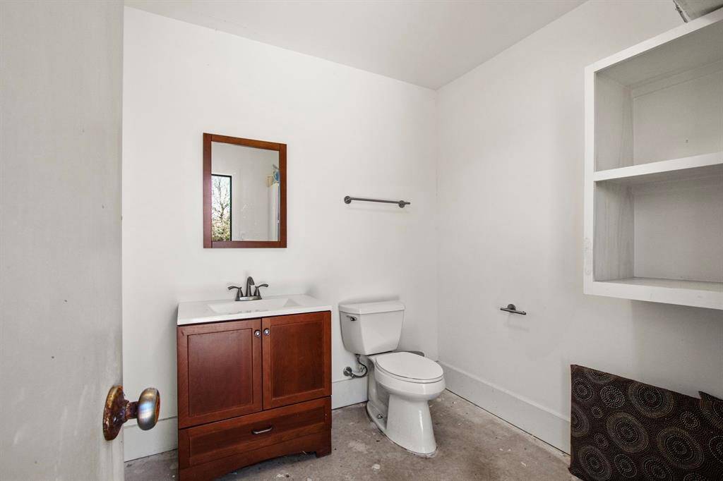 There is a convenient outdoor pool Bath featuring built-in shelves, a stylish furniture-style sink and wall A/C adding both functionality and charm to the outdoor space.