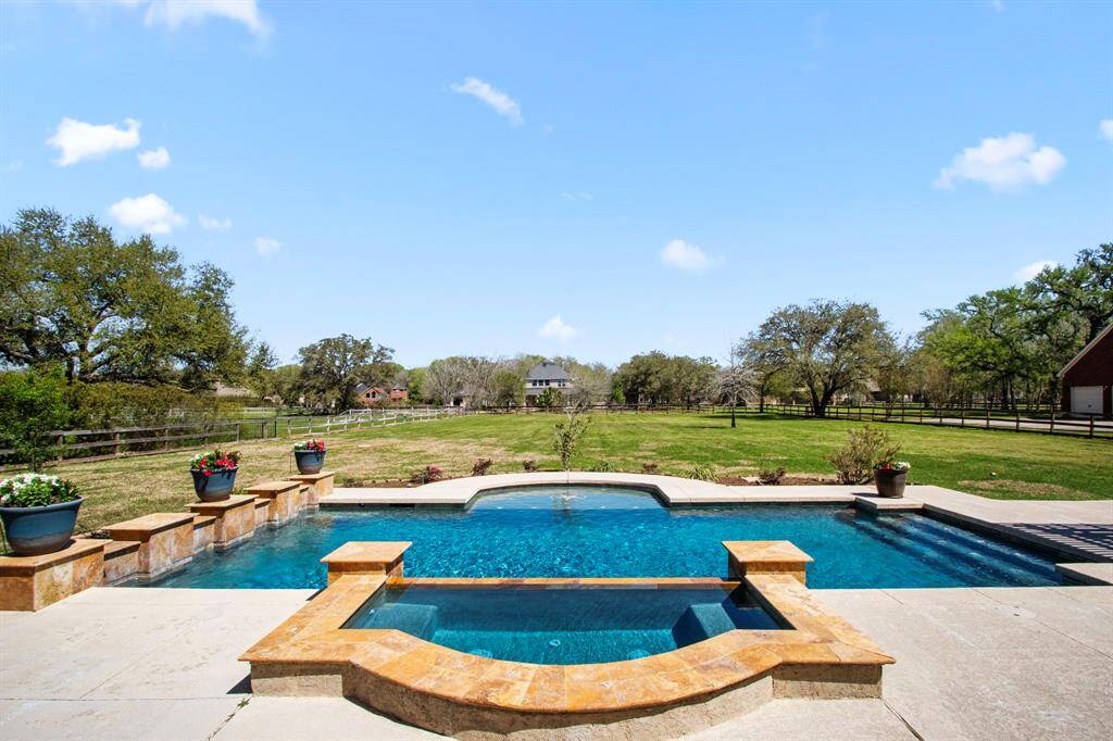 Take a dip in this gorgeous chlorine pool and spa, crafted by Pool Pro Consultants in 2014, and accented with beautiful flagstone detailing. Whether you're unwinding in the spa or splashing in the pool, every moment offers relaxation and fun. Enjoy breathtaking views that stretch as far as the eye can see, all set within a huge backyard that provides endless possibilities for outdoor living.