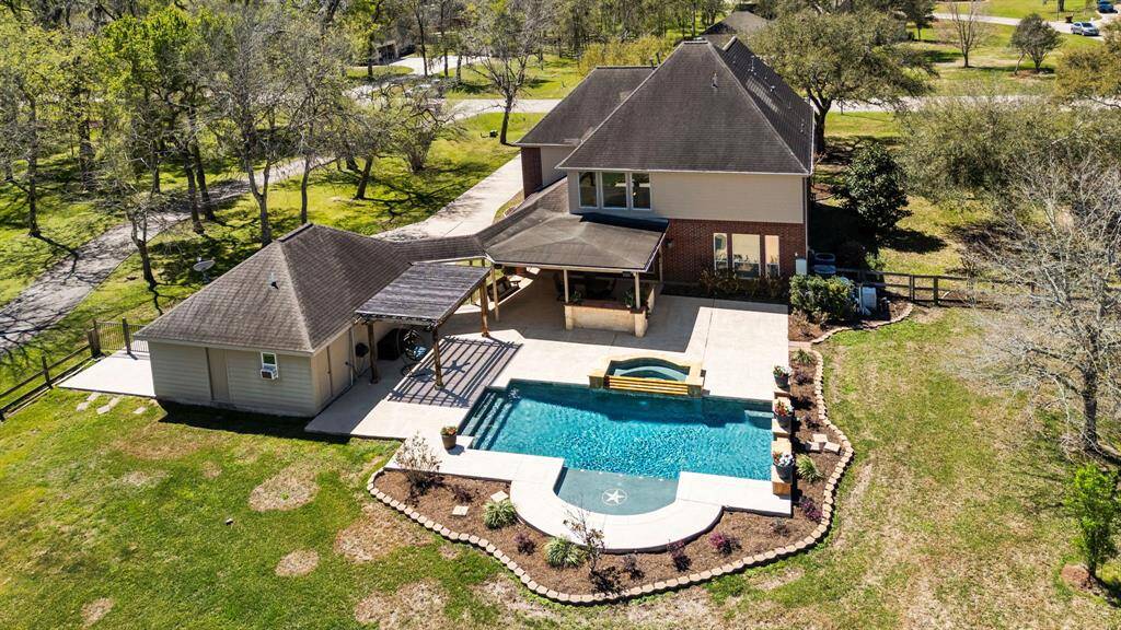This view offers a closer look at this gorgeous property, highlighting its expansive layout, beautiful landscaping, and stunning outdoor amenities.
