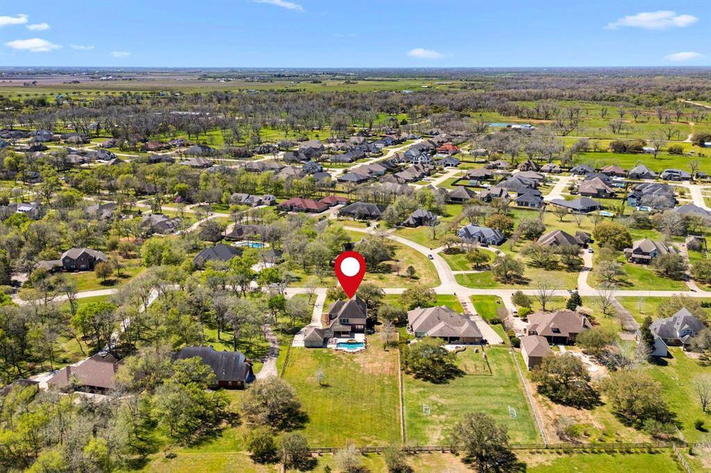 This view is looking from the rear of the property toward the west, capturing the expansive backyard and the beautiful evening sunsets this home enjoys.