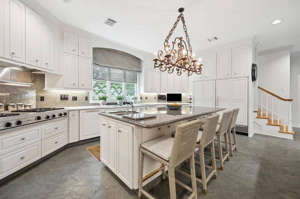 A timeless kitchen awaits at Overbrook. Island is unusually large for its time, antique French chandelier, Viking gas range, vegetable sink, walk-in pantry with old English etched door, side by side Sub Zero refrigerator/ freezer and abundant storage. You can spot the second staircase leading to the bedrooms and offices upstairs. There’s also a second powder room nearby.