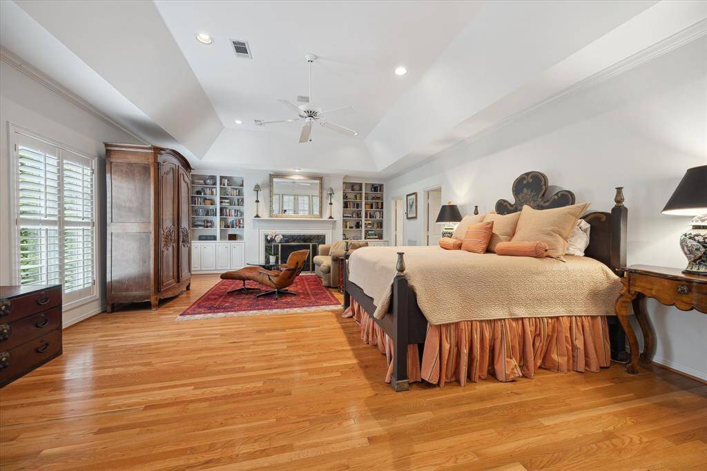 The primary suite with its vaulted ceiling is gigantic! You can have multiple sitting areas by the fireplace or by the screened balcony, which is off the primary bedroom. So many options.