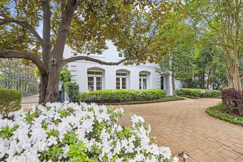 Original owners have given the home so much tender loving care. Notice the beautiful landscaping and trees. The home has ample parking with its circular driveway, electric gate and more parking with the garage and long driveway in the back.
