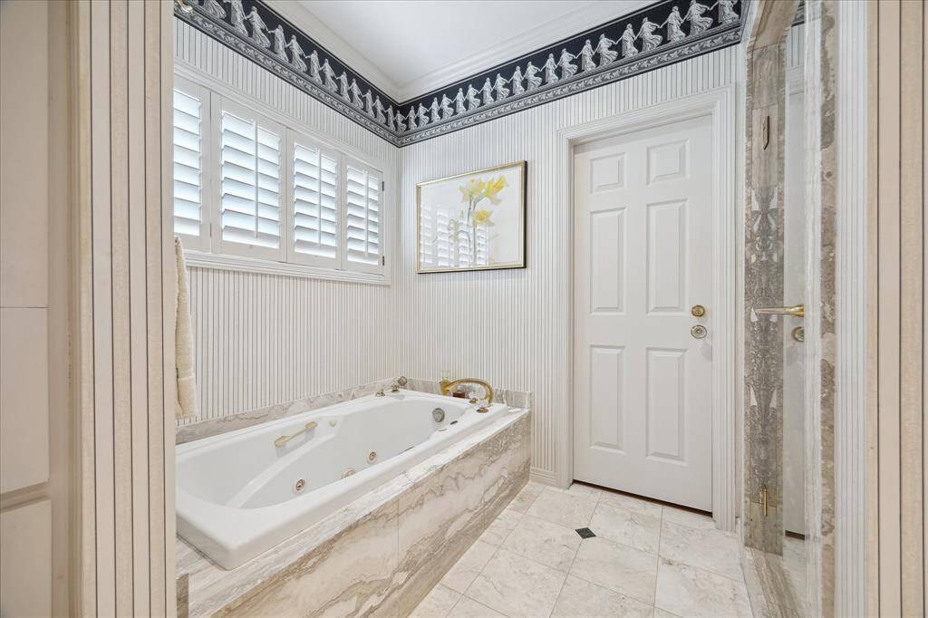 A closeup of the jetted tub leading to one of the two large walk-in closets. Again, so much space!