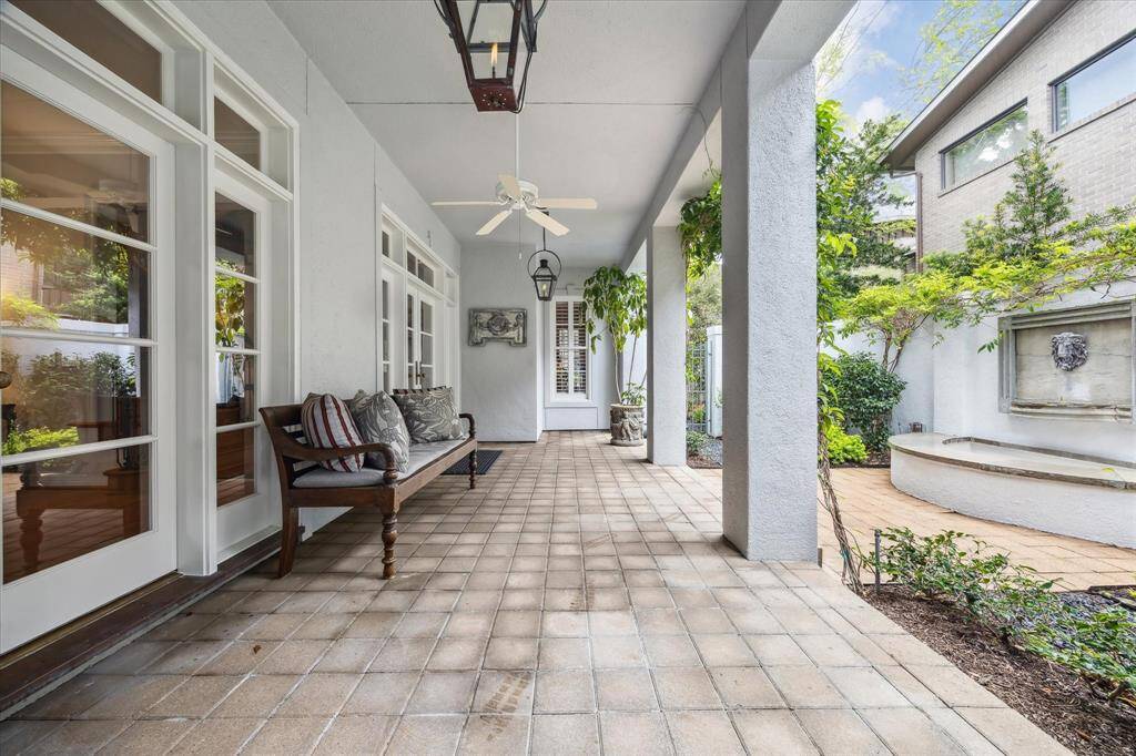 Fall in love with the pretty porch that covers the entry. Notice the Bevolo gas lanterns lighting the way.