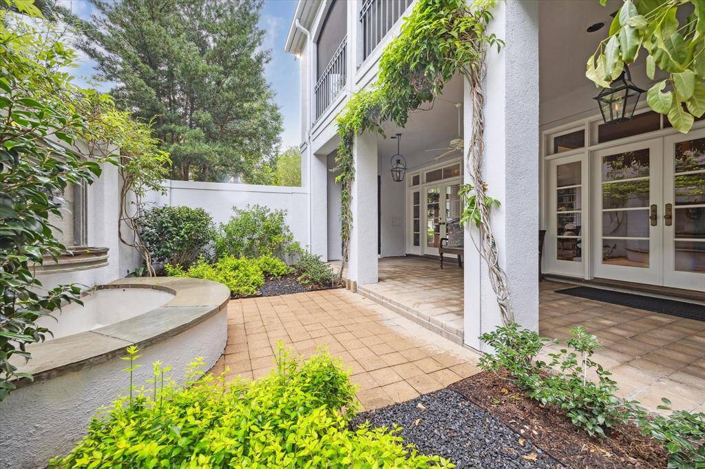 Another view of the front porch and entry reflecting the trickling fountain and the lush green landscaping that surrounds the home. Beautiful views everywhere!