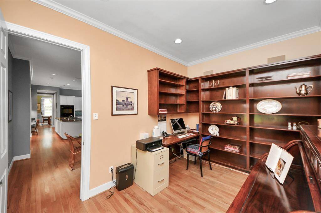 The private study, conveniently positioned off the kitchen, includes built-in cabinetry—offering flexibility as a home office or a well-appointed butler’s pantry.