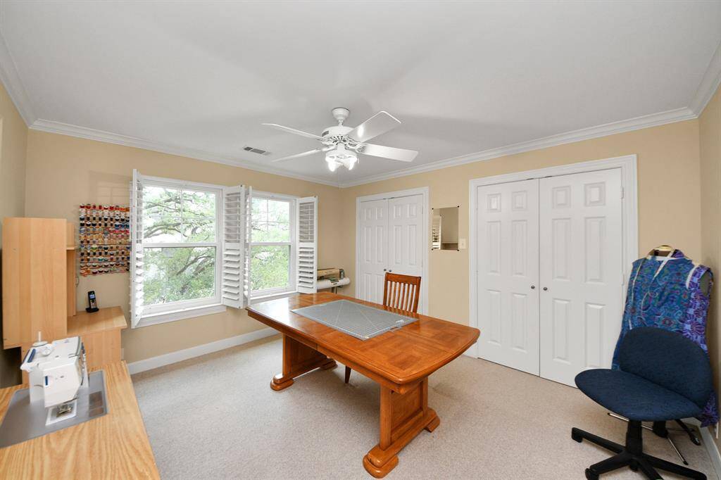 Bedroom 2 now serving as a craft room, includes a shared Hollywood bath—ideal for guests, family, or creative space.