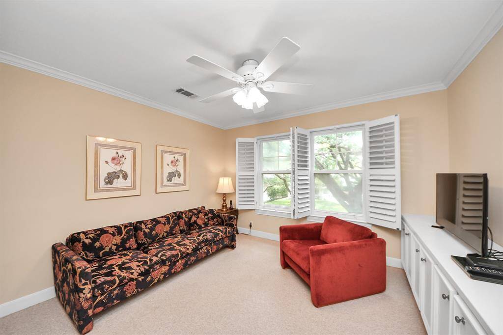The third bedroom has been transformed into a cozy sitting and entertainment room—perfect for relaxing, reading, or movie nights.