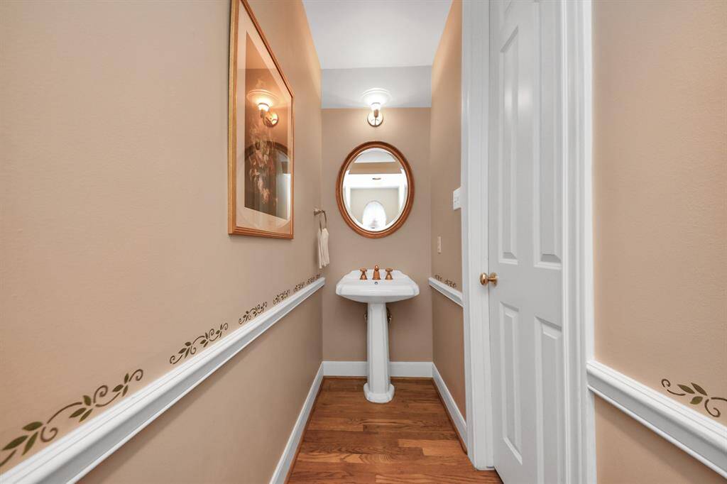 Thoughtfully placed powder room offers a welcoming touch for guests.