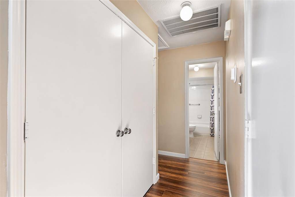 The laundry room is behind the doors on the left. The hallway leads to the secondary or guest bathroom and after you make the turn you will find 2 more secondary bedrooms.