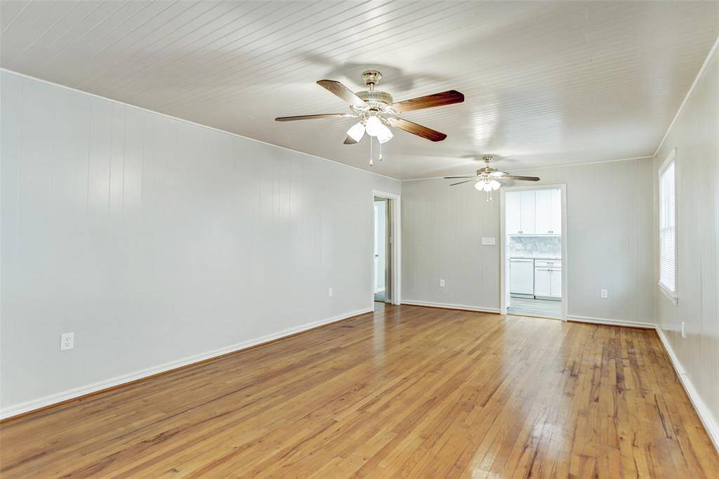 Another view of the large Living Space - boats original Maple hardwoods, sparkling windows and blinds, ceiling fans and light kits, storage closet and more! Ideal for multiple uses, such as Living Rm and Study and Dining Room - Great layout and flow!