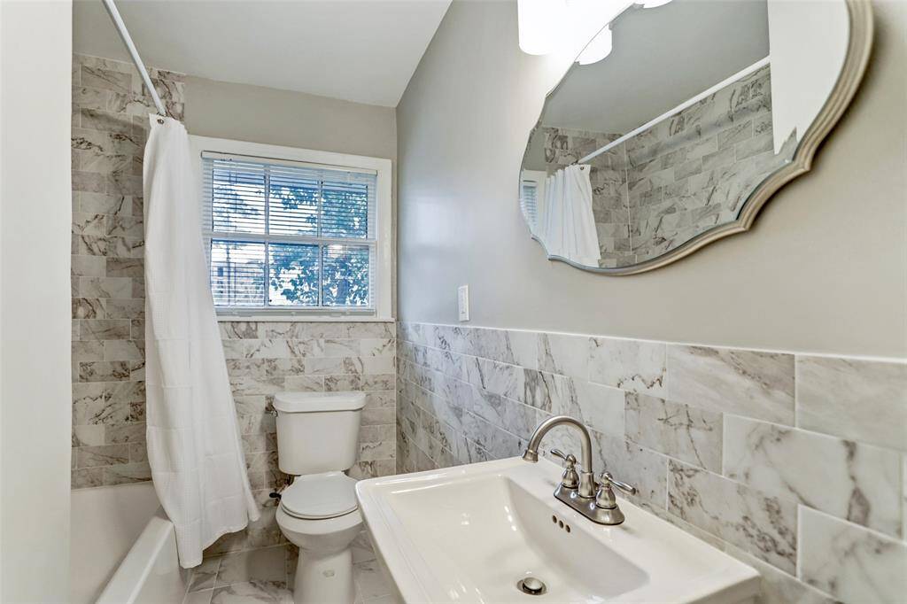 Remodeled bath conveniently located in the hall between the two spacious bedrooms.