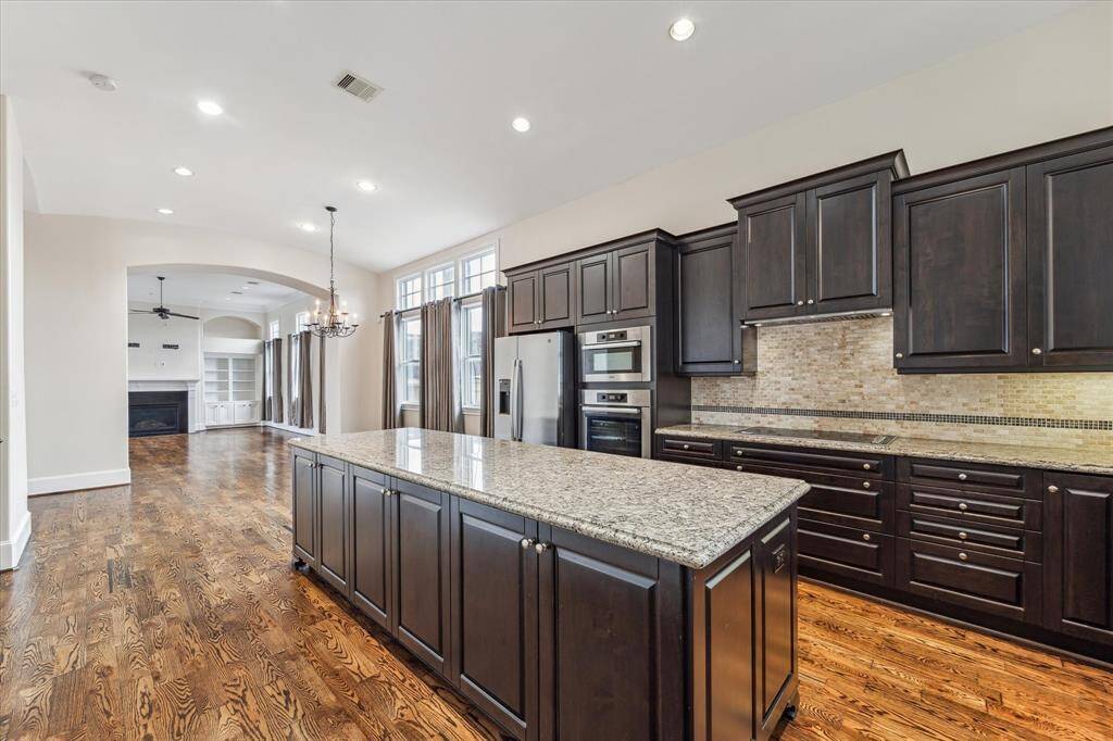 Another view of the kitchen with ample storage looking to the dining and living area