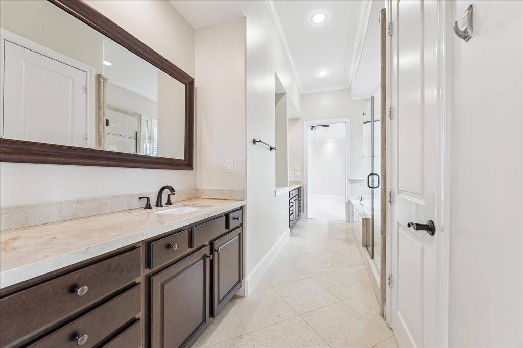 Primary bathroom with dual sinks looking to the primary bedroom