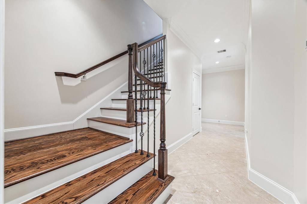 Entry with access to garage, secondary bedrooms, full bath, closet and hardwood stairs to the living spaces.