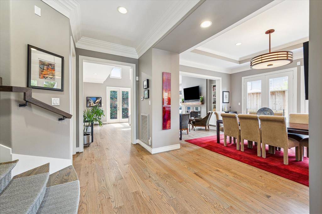 View from entry hall toward large living area and with dining room on the right