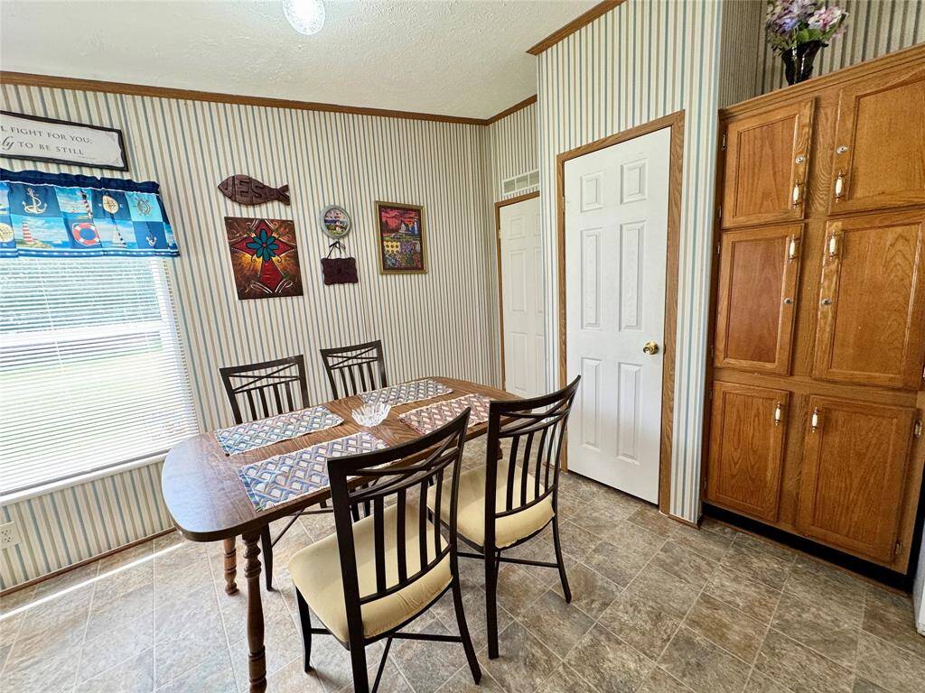 Far door to L to Utility room, side door, and half bath