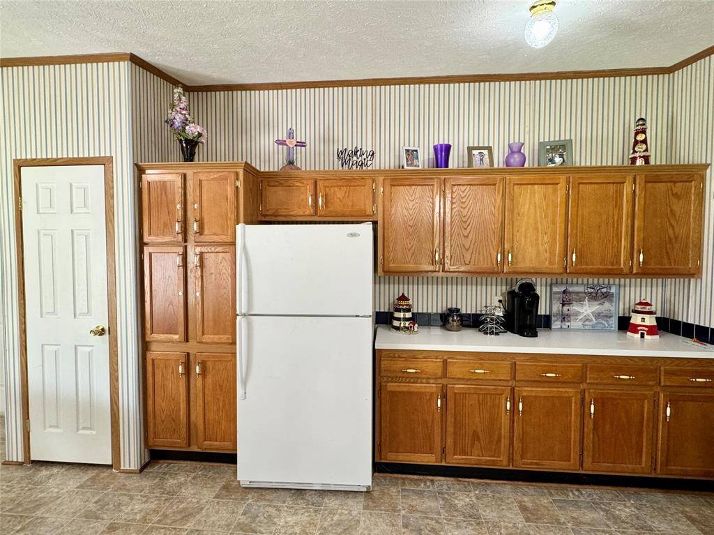 White door is a pantry, and the cabinet next to the refrigerator can be storage or a 2nd pantry! There is tons of storage in this house!