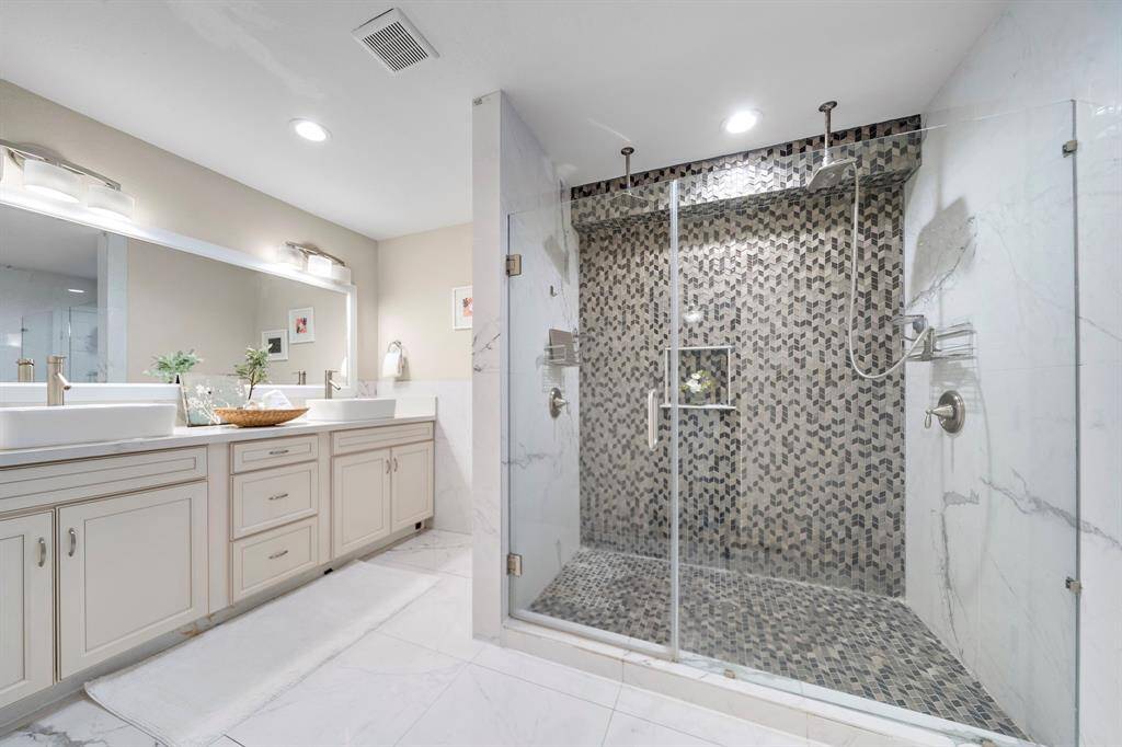 Primary bathroom with glass surround walk-in shower.