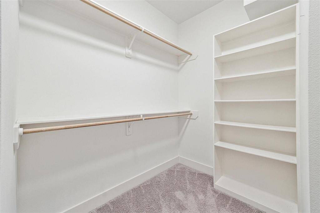 Walk in Closet #2 located within the Primary Bathroom also has custom shelving.