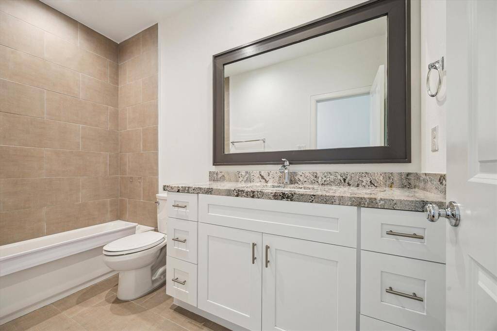Secondary Bathroom located between the two secondary bedrooms features a tub.