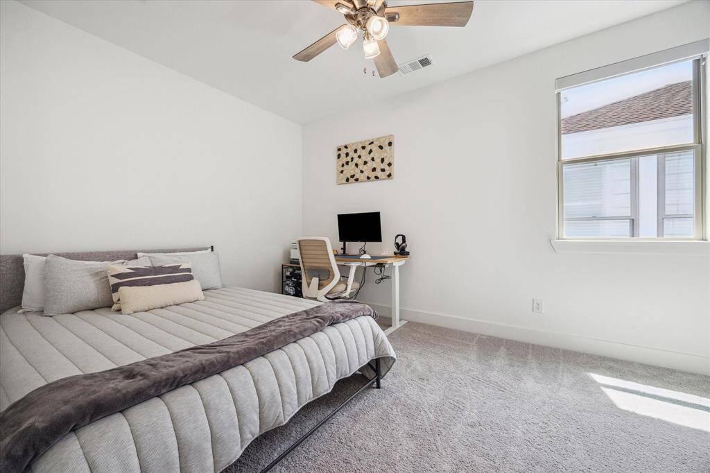 Secondary Bedroom #2 is spacious enough to fit a queen size bed and a desk. This room also has a walk in closet.