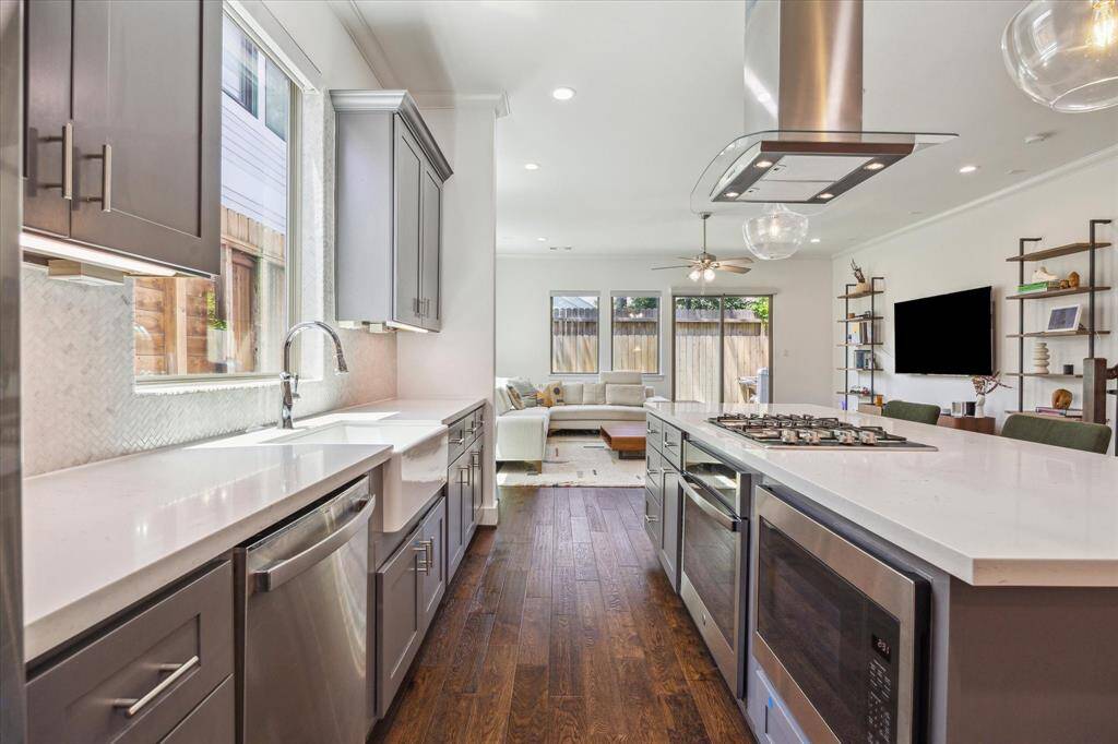The Kitchen has 42 inch cabinets, built in microwave in the island, plenty of counterspace & has undercabinet lighting that highlights the neutral upgraded backsplash. Outlets are located underneath the cabinets keeping the backsplash uninterrupted.