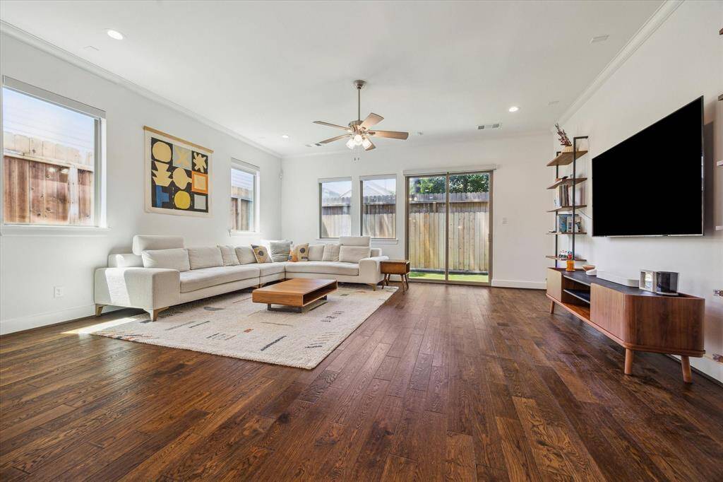 Engineered hardwood floors, recessed lights, crown molding, large baseboards & a sliding glass door leading to your maintenance free yard are featured here.