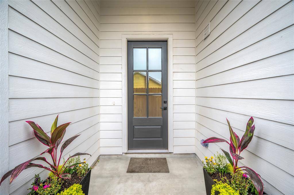 Large covered entryway with 8' solid wood door