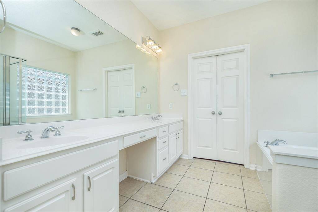 generous master closet with wood floor