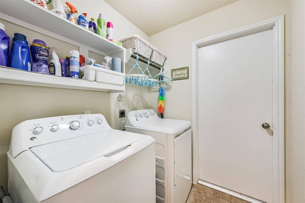 Garage entry is through the utility room. Washer and dryer are included. Owners installed shelving for optimal usage of the room.