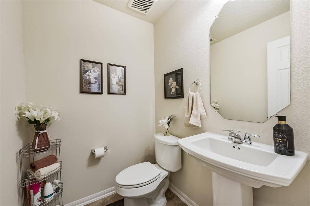 The half bath is located toward the front of the home for ease of guest use.