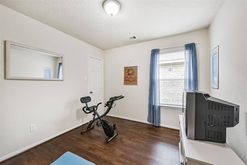 The third bedroom is in the middle of the hallway.