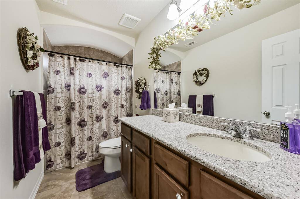 The hallway full bathroom to be shared amongst the three bedrooms in addition to the half bath. Featuring a shower/tub combo and extended vanity for optimal counter and storage space.