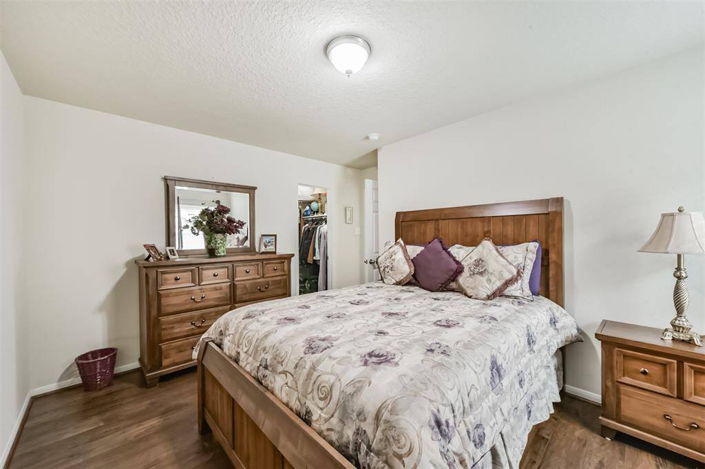 The fourth bedroom is located at the end of the hallway and features a walk-in closet.