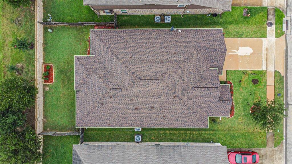 Aerial view showing full property and new roof.